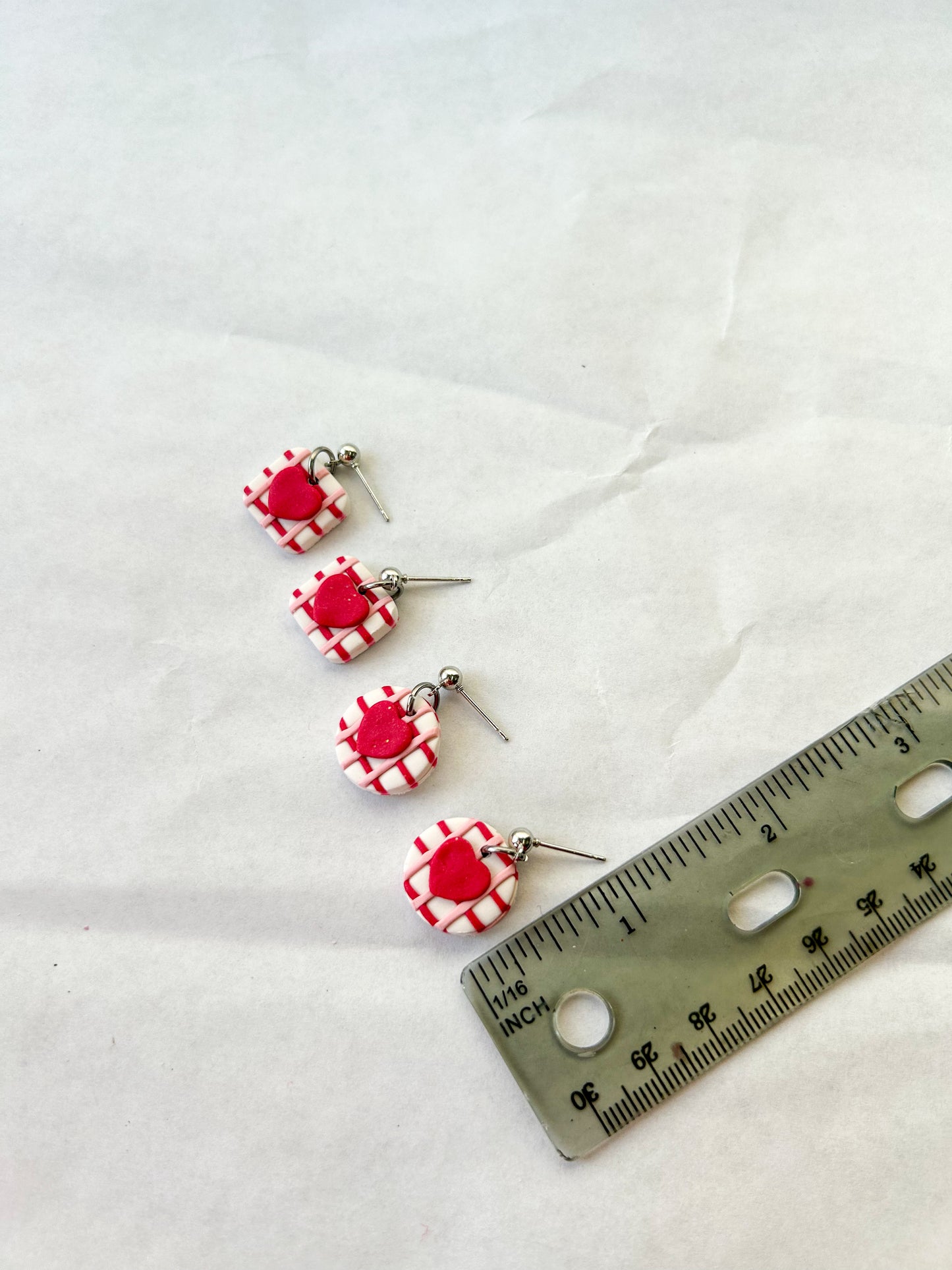 Earrings next to a ruler to show that they are about 3/4 of an inch in length