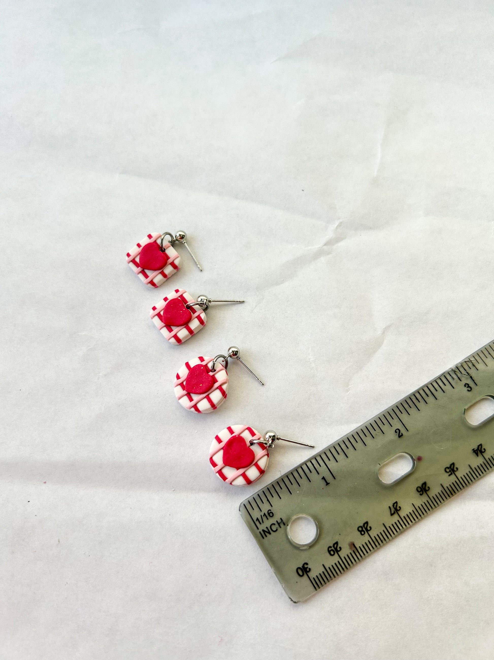 Earrings next to a ruler to show that they are about 3/4 of an inch in length