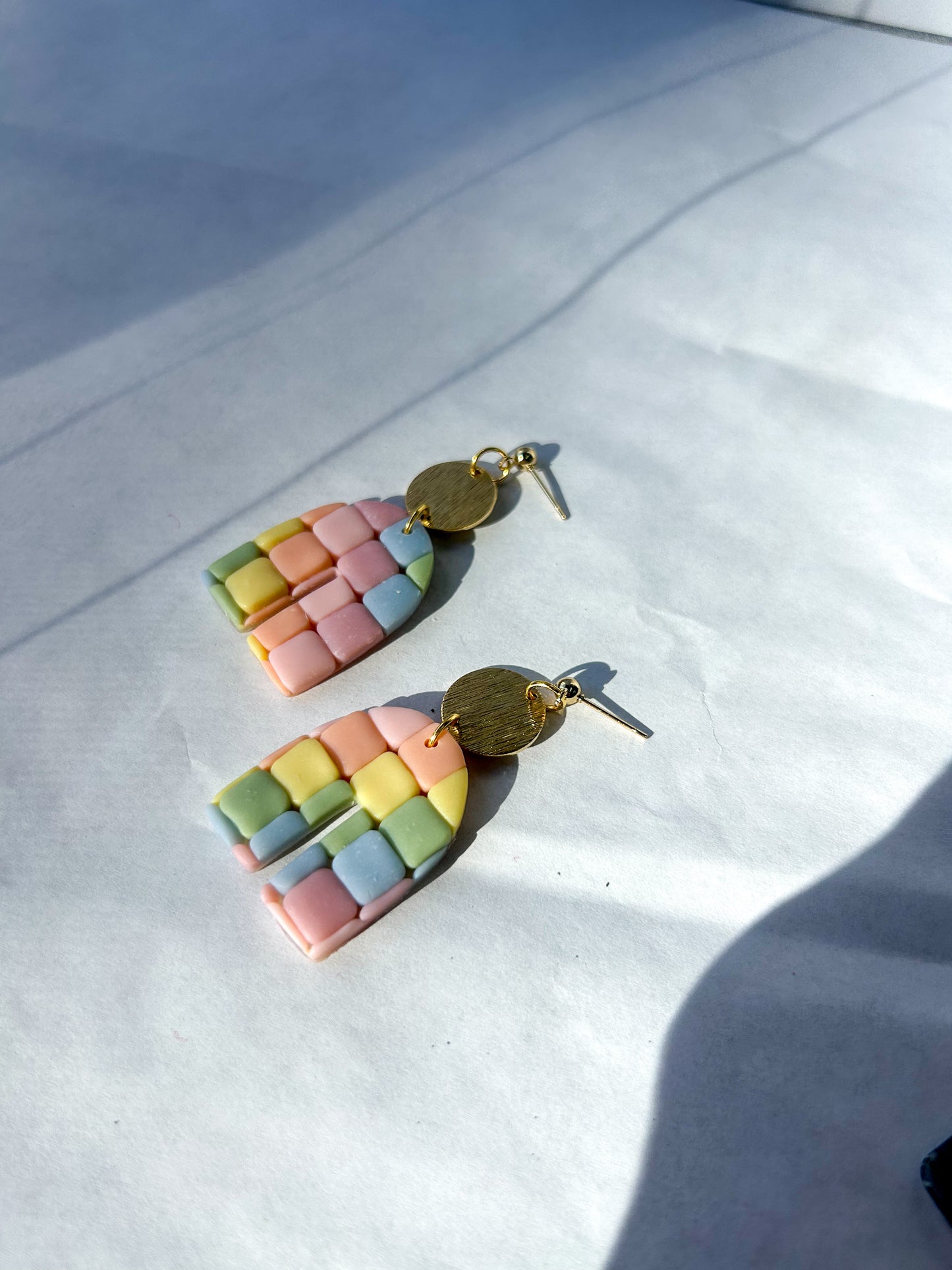 Colorful geometric earrings on a white surface