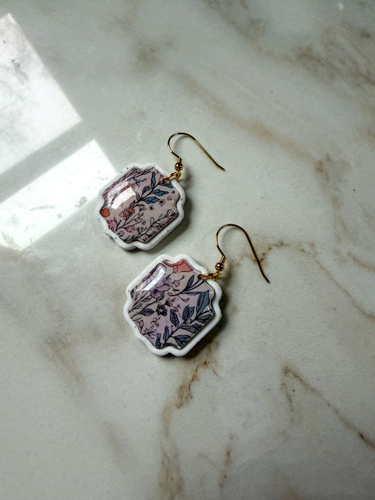 Floral earrings on a marble surface