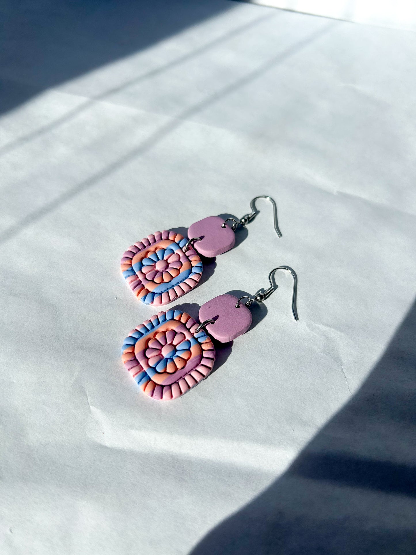 Colorful earrings on a white surface