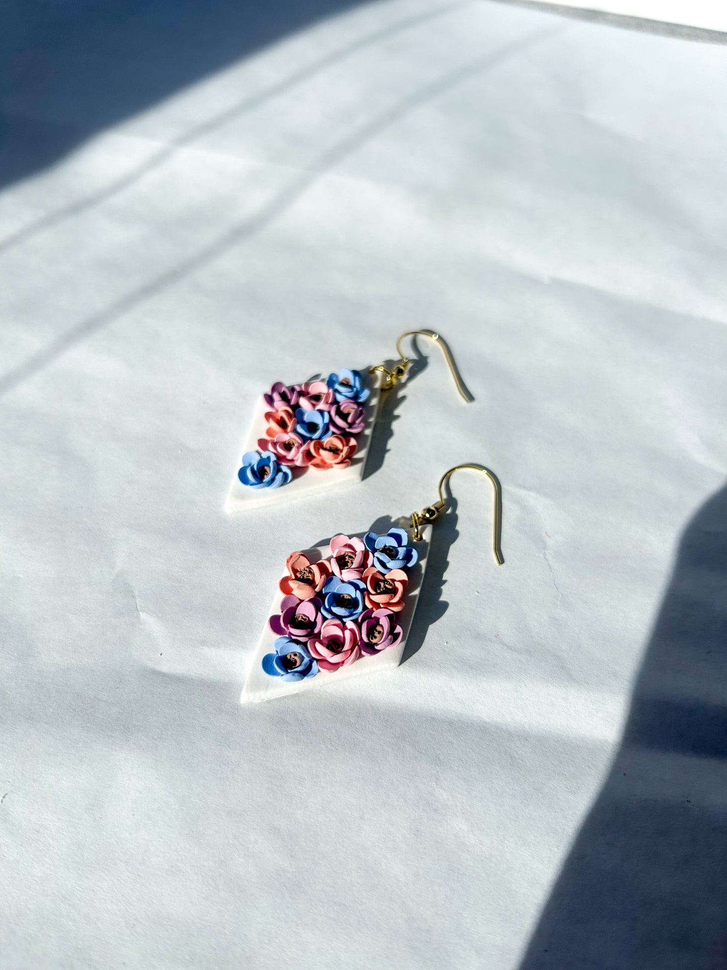 Pair of colorful earrings on a white surface