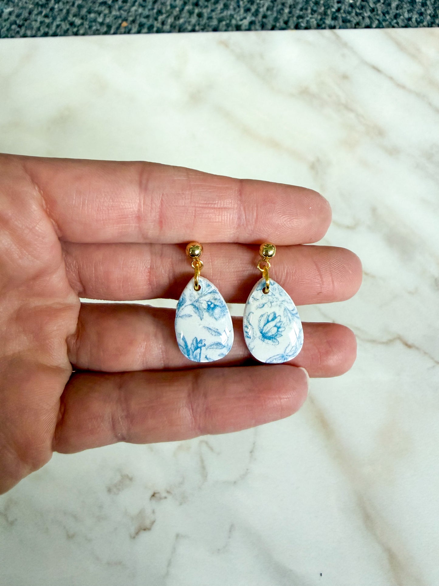 Blue floral design on a teardrop shaped dangle 
