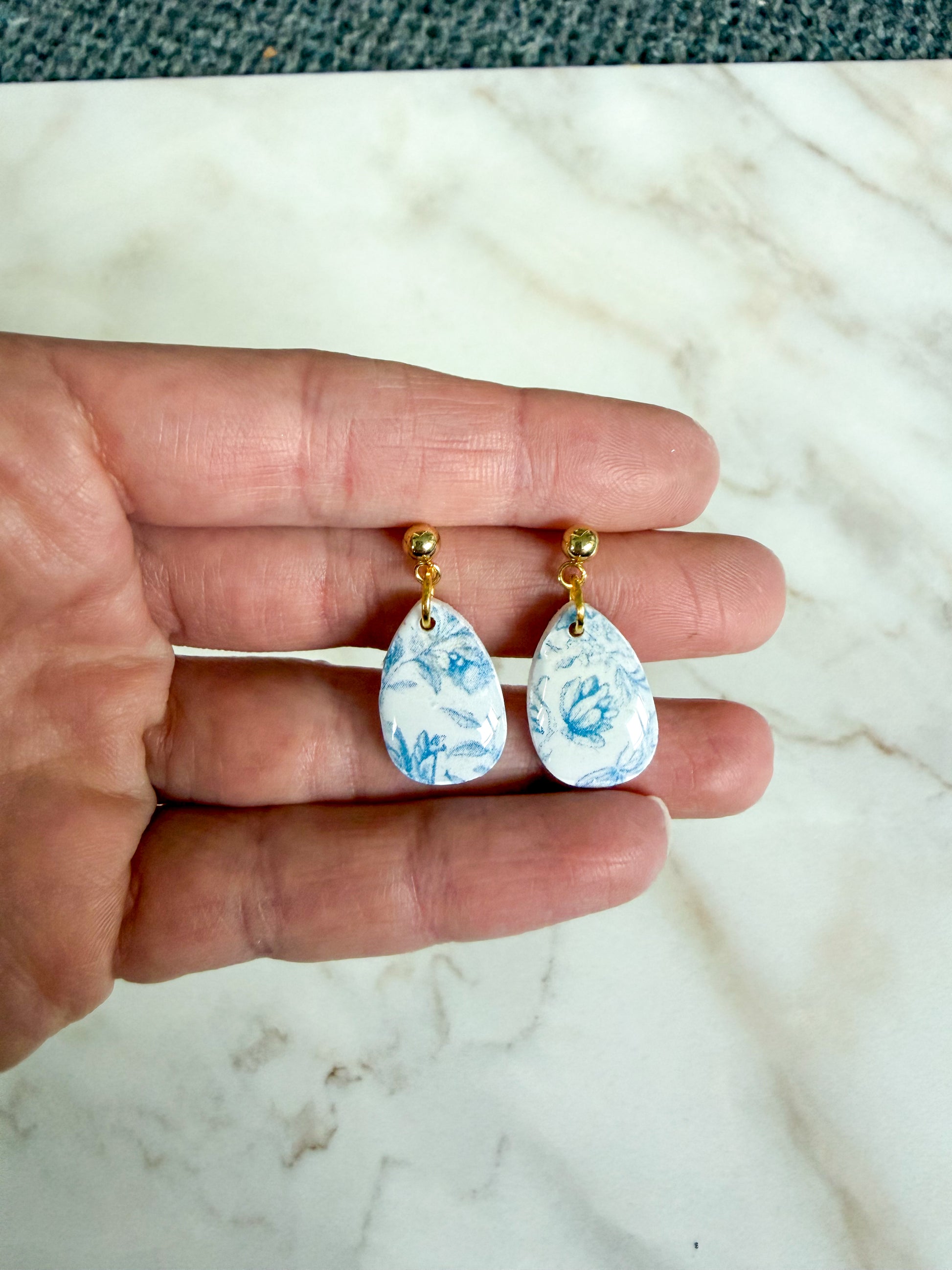 Blue floral design on a teardrop shaped dangle 
