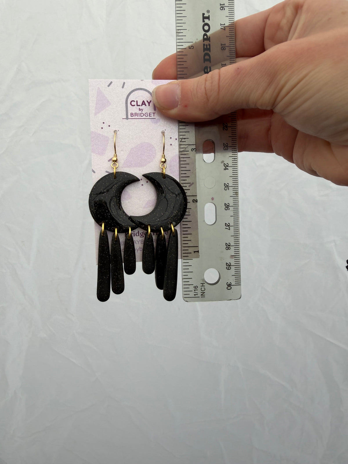 Earrings held against your ruler for scale. About 3.25 inches in length.