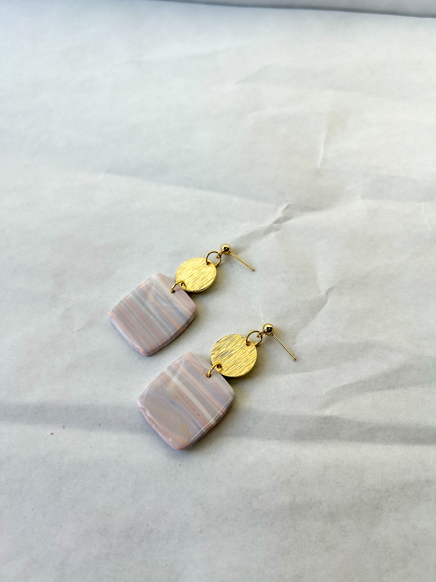 Pair of marble earrings laying on a flat surface